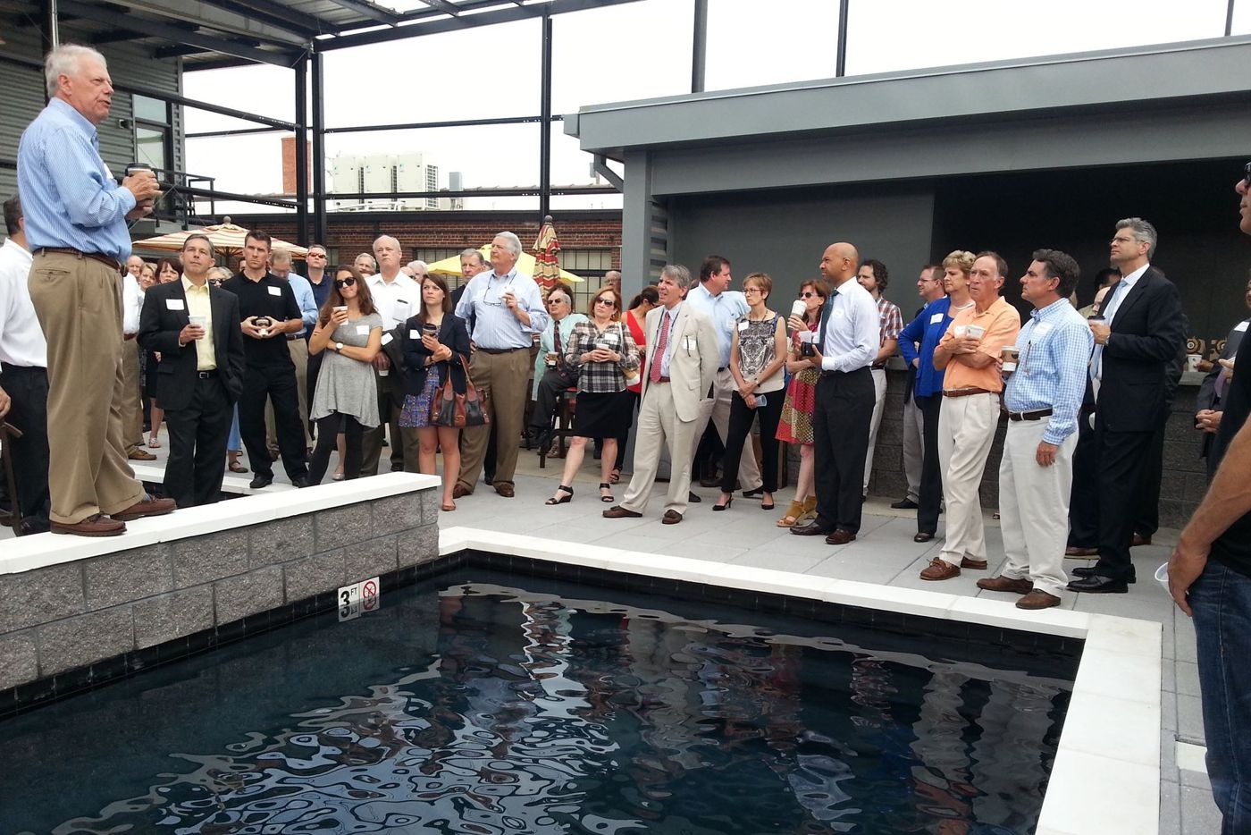 Encorepreneurs gather around a rooftop pool in Scott's Addition